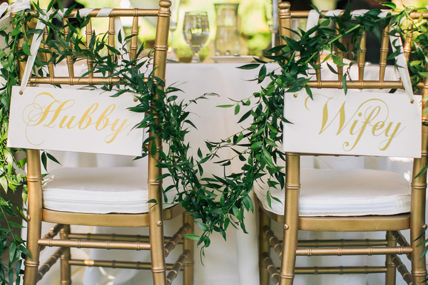 picture of greenery decorating chairs at a wedding