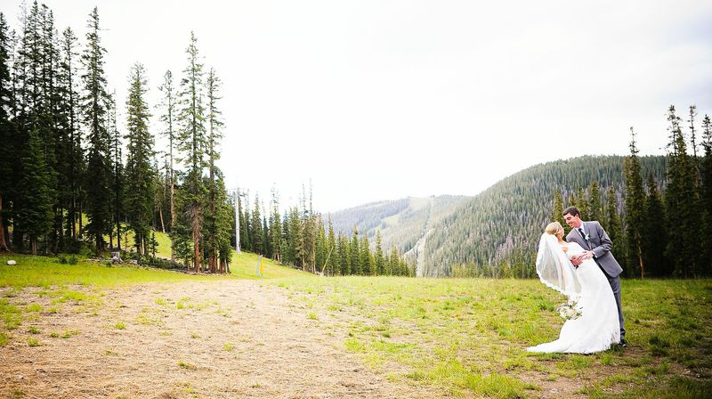 picture of a bride and groom kissing at Timber Ridge in Keystone, Colorado