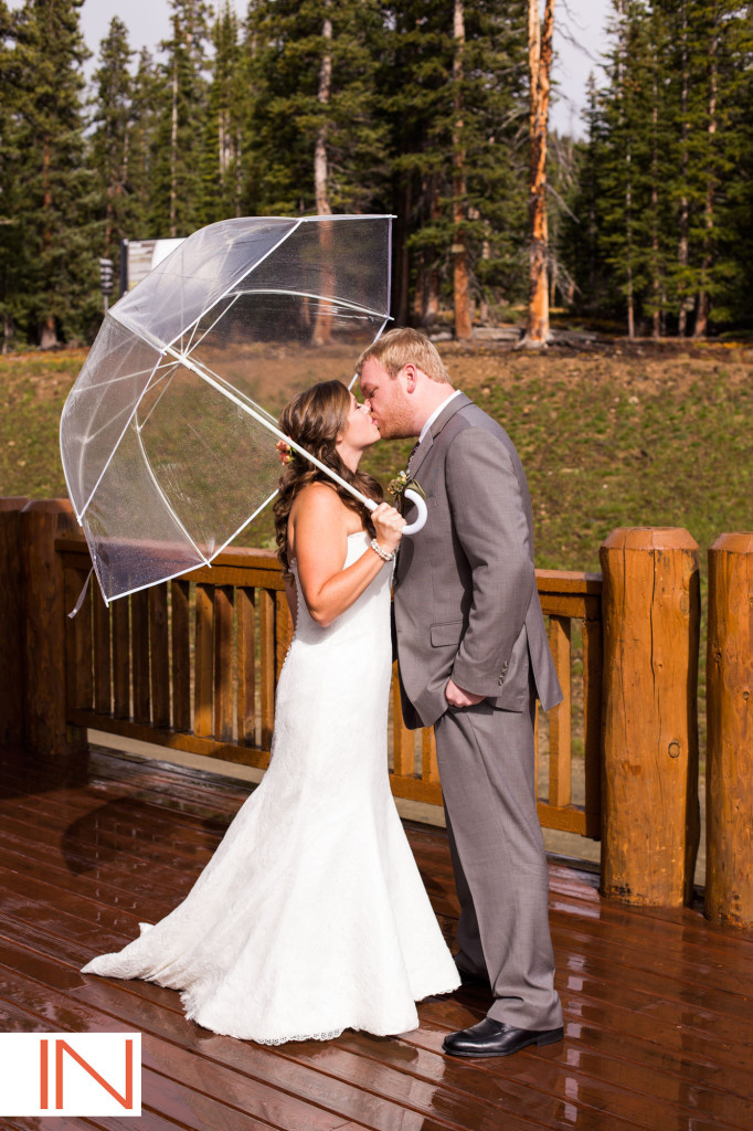 Picture of a bride and groom under an umbrella